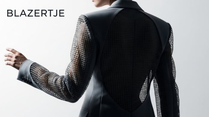 Model in black blazertje with mesh back and sleeves.